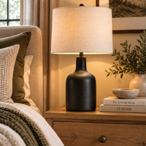 22-inch black ceramic table lamp with oatmeal linen shade on a wood table