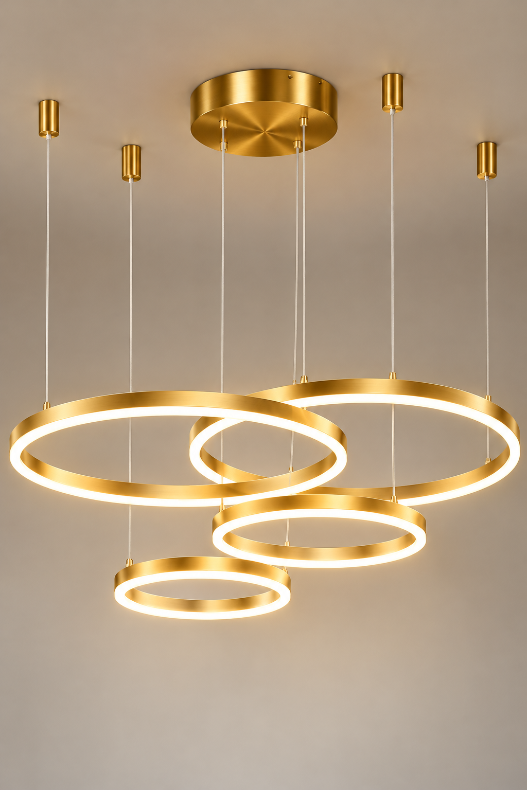 Gold ring chandelier with four geometric LED rings and warm white lighting